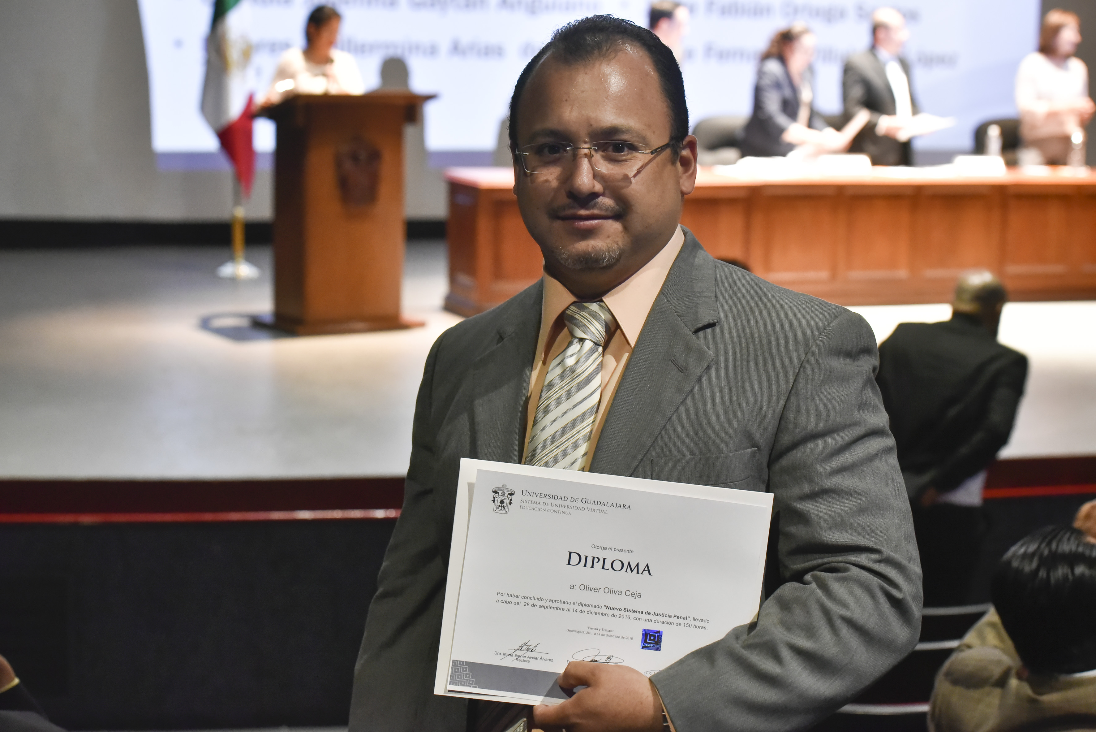 Oliver Oliva Ceja, funcionario de dependencia de Gobierno del Estado, mostrando diploma de acreditación.